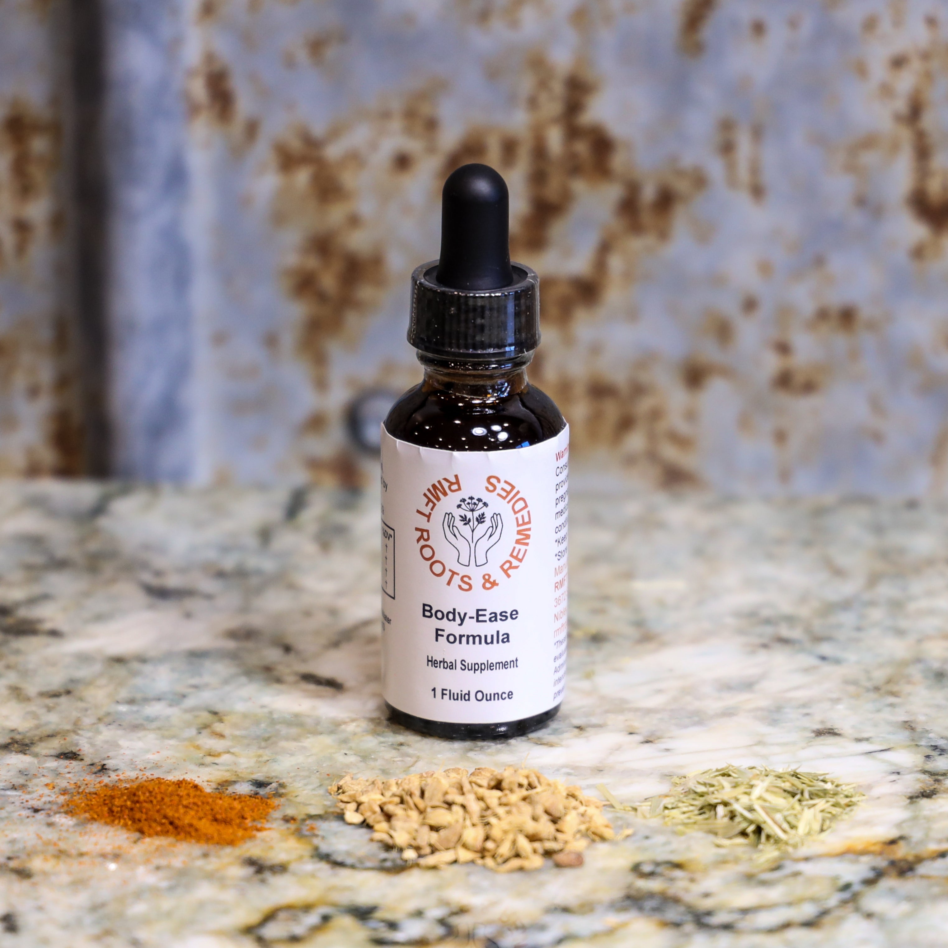 Bottle of 'Body-Ease Formula' on a textured surface with dried herbs.