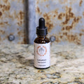 Bottle of Lomatium herbal supplement on a marble surface