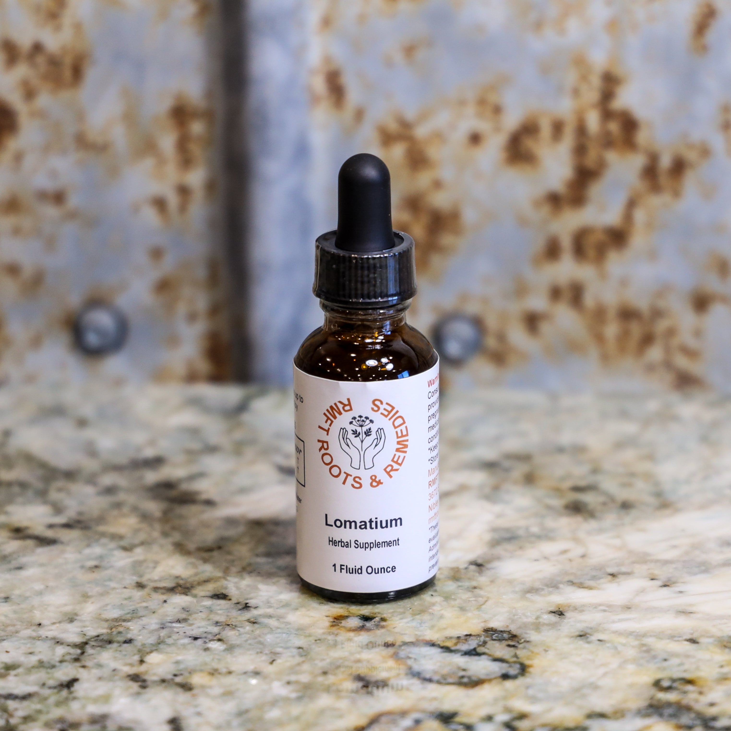 Bottle of Lomatium herbal supplement on a marble surface