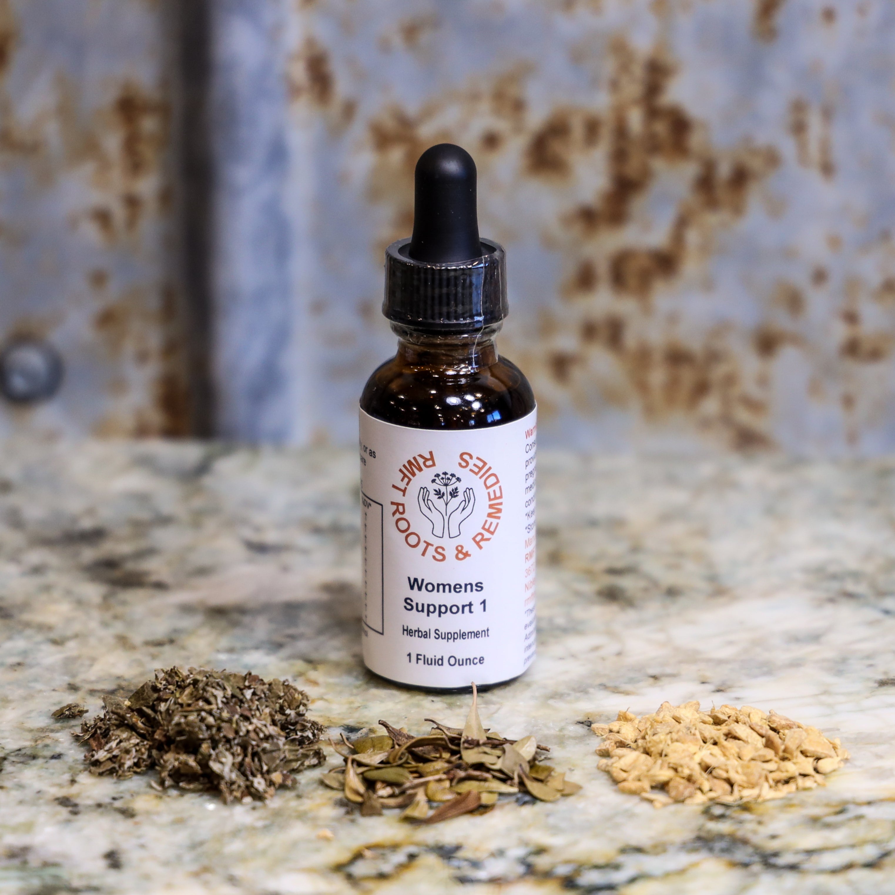 Bottle of 'Women's Support 1' herbal supplement with dried herbs on a textured surface
